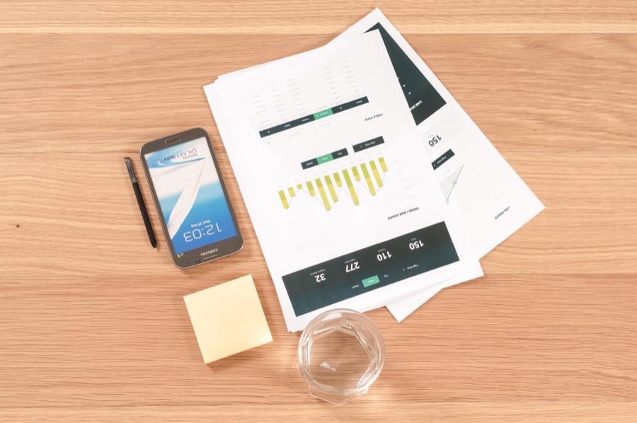 Printed charts and reports spread across a desk