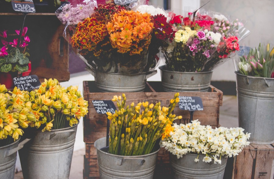 Buckets of cut flowers displayed outside a local florist